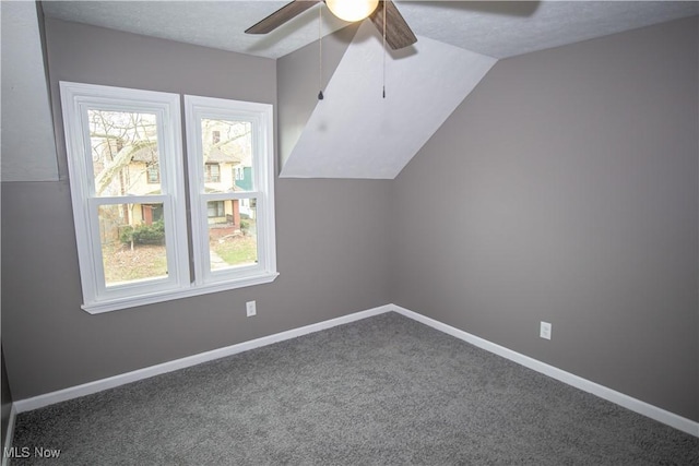 additional living space featuring ceiling fan, vaulted ceiling, carpet, and plenty of natural light