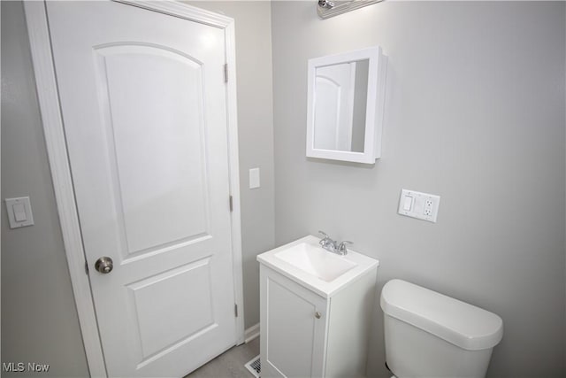 half bathroom with toilet and vanity