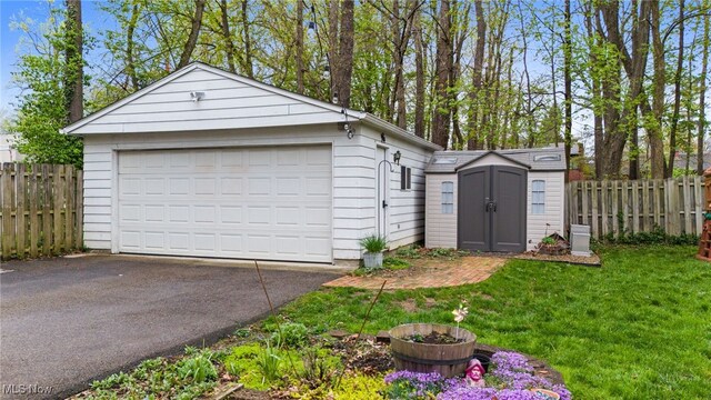 142 Gillett St, Painesville, OH 44077 - detached garage with a storage unit and fence