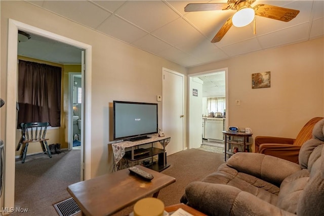 carpeted living room with a ceiling fan
