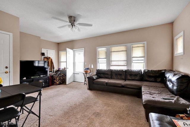 carpeted living room with ceiling fan and a healthy amount of sunlight