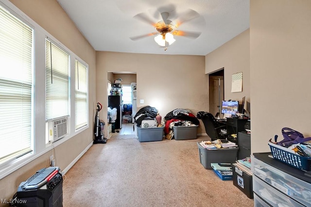 interior space featuring a ceiling fan, carpet floors, and plenty of natural light
