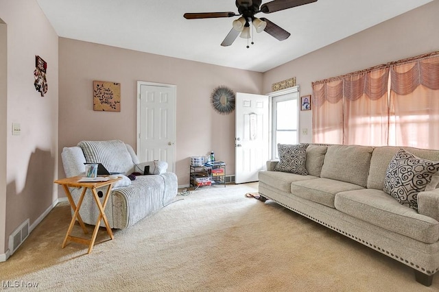 living room featuring baseboards, visible vents, light carpet, and ceiling fan