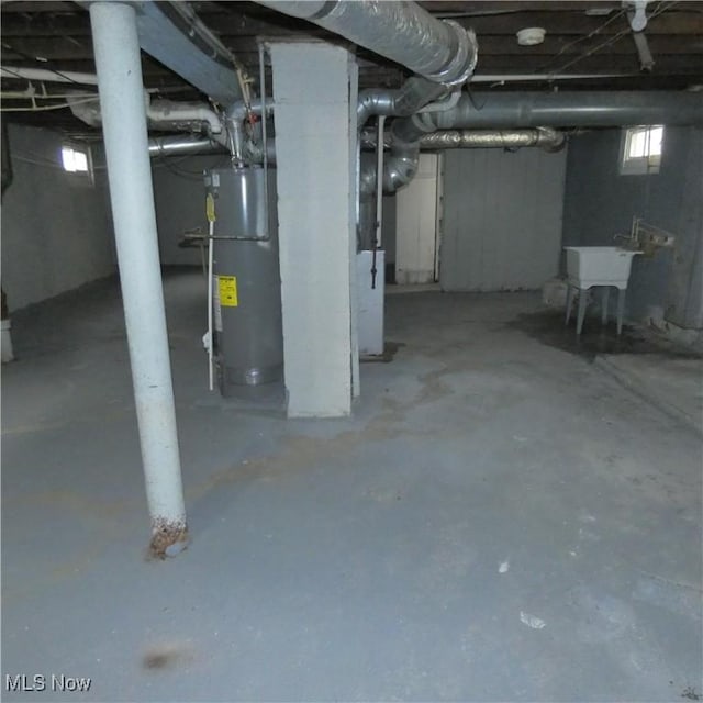 10921 Dove Ave, Cleveland, OH 44105 - below grade area featuring water heater and a sink