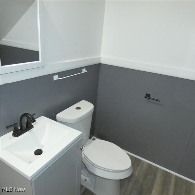 10921 Dove Ave, Cleveland, OH 44105 - half bath with toilet, vanity, and wood finished floors