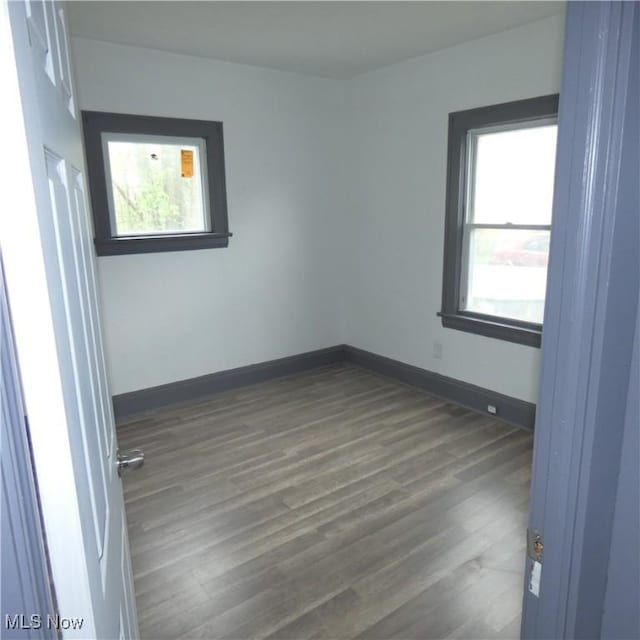10921 Dove Ave, Cleveland, OH 44105 - empty room with dark wood-style flooring and baseboards