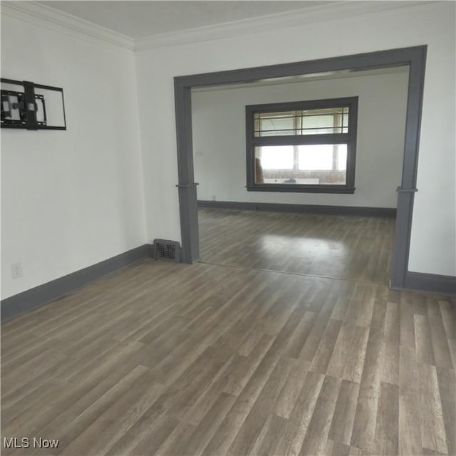 10921 Dove Ave, Cleveland, OH 44105 - empty room with wood finished floors, crown molding, visible vents, and baseboards