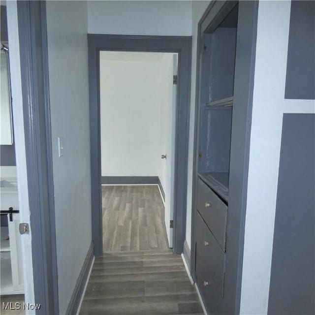 10921 Dove Ave, Cleveland, OH 44105 - corridor with baseboards and dark wood-type flooring