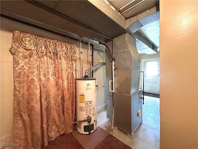 utility room with heating unit and water heater