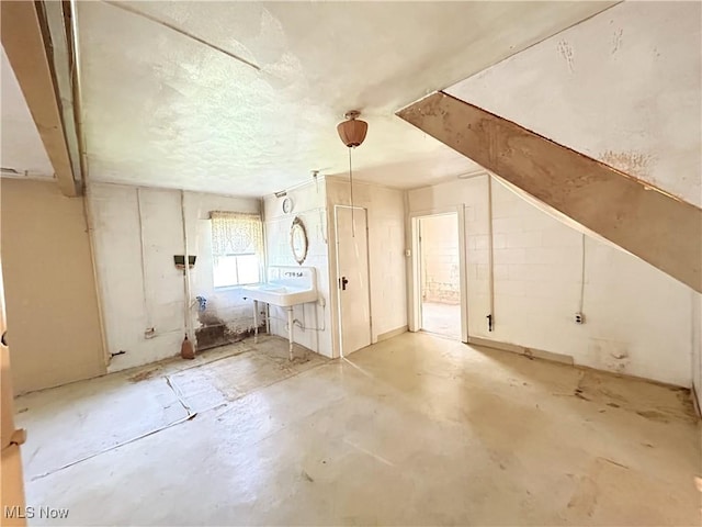 bonus room with unfinished concrete flooring