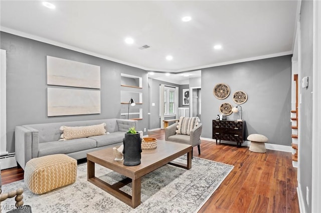 living area with baseboards, recessed lighting, wood finished floors, and crown molding