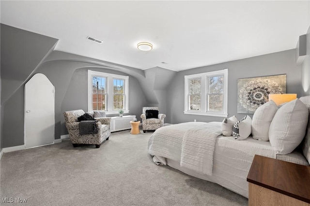 carpeted bedroom with visible vents and baseboards