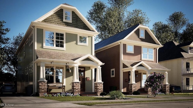 view of front of home with covered porch and stone siding