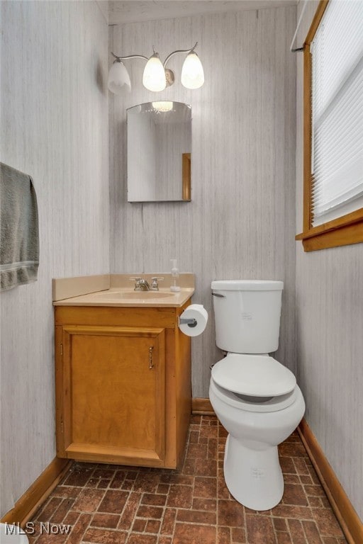 340 53rd St SW, Canton, OH 44706 - half bathroom featuring vanity, toilet, brick patterned floor, and baseboards
