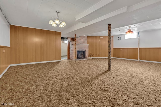 340 53rd St SW, Canton, OH 44706 - unfurnished living room with a fireplace, wooden walls, carpet flooring, and an inviting chandelier