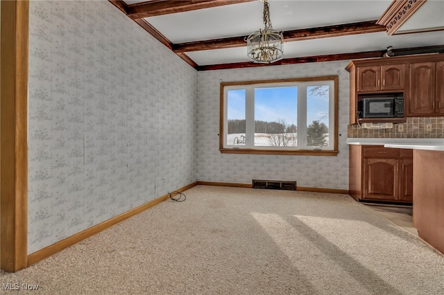 340 53rd St SW, Canton, OH 44706 - interior space with beamed ceiling, visible vents, baseboards, wallpapered walls, and light colored carpet