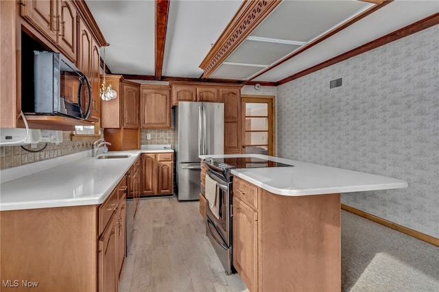340 53rd St SW, Canton, OH 44706 - kitchen with wallpapered walls, stainless steel appliances, brown cabinetry, a sink, and a center island