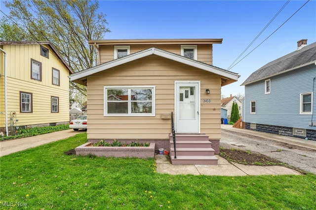 view of front facade with a front yard and entry steps