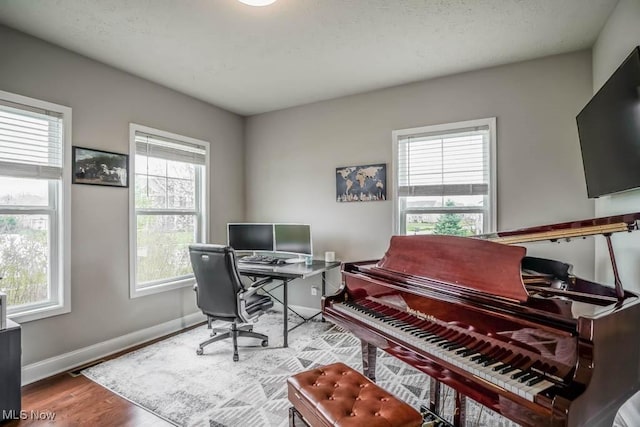 home office with wood finished floors and baseboards