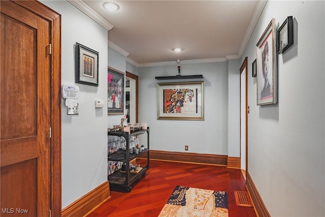 hallway featuring visible vents, baseboards, recessed lighting, ornamental molding, and wood finished floors