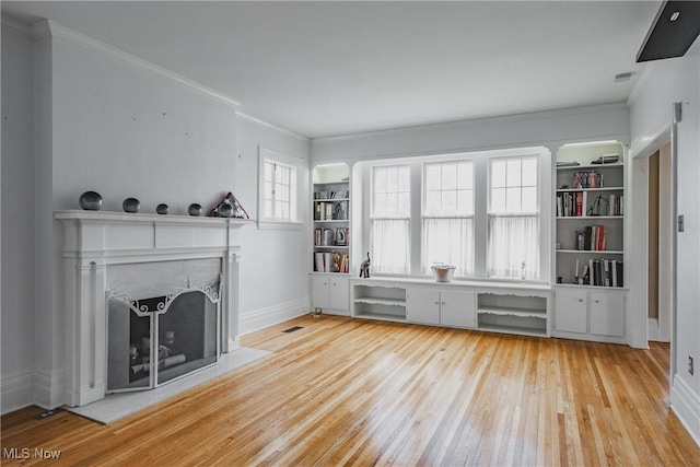 unfurnished living room with baseboards, light wood-style floors, crown molding, and a fireplace