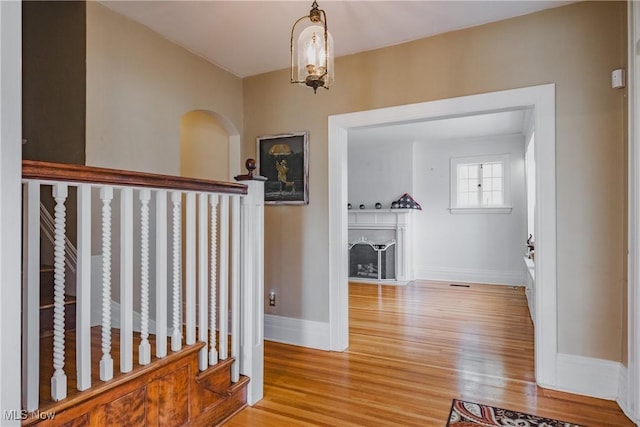 hall with wood finished floors and baseboards
