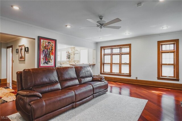 living area featuring baseboards, recessed lighting, ornamental molding, wood finished floors, and a ceiling fan
