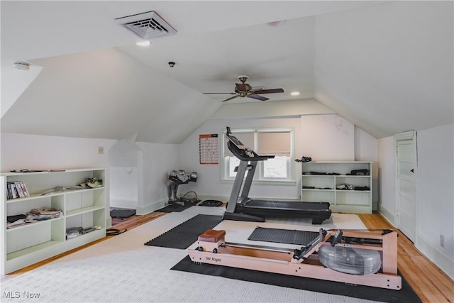 exercise area with ceiling fan, wood finished floors, visible vents, baseboards, and lofted ceiling