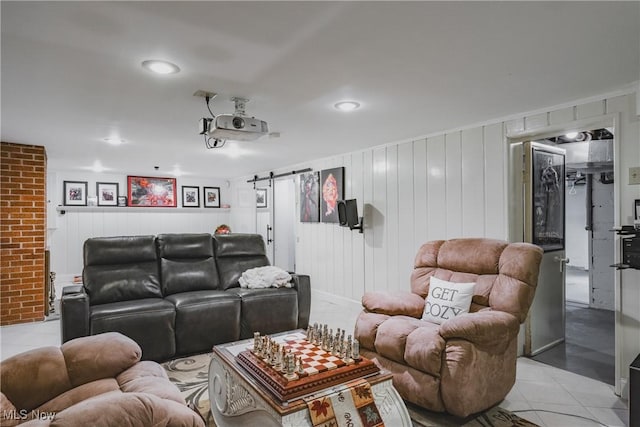 home theater with a barn door, light tile patterned floors, and recessed lighting