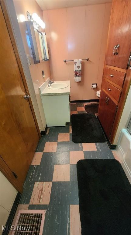 bathroom with tile patterned floors, toilet, and vanity