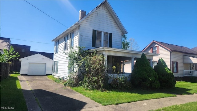 view of front of home featuring a porch, a front yard, a garage, an outdoor structure, and a chimney