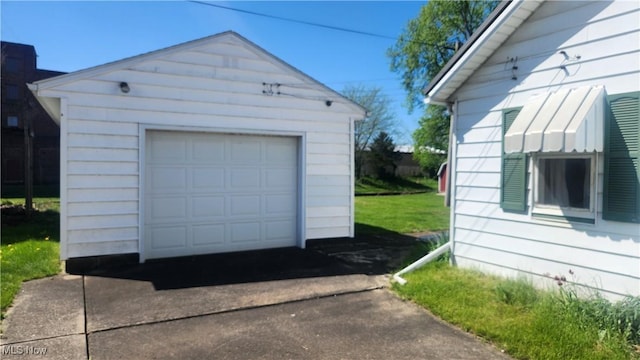detached garage featuring driveway