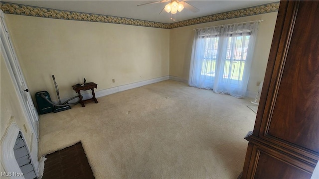 empty room with baseboards, light carpet, and ceiling fan
