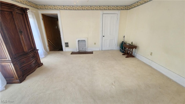 interior space featuring baseboards, visible vents, and carpet flooring