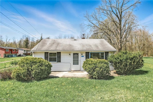 2258 Jacobs Rd, Youngstown, OH 44505 - view of front facade with a chimney, a shingled roof, and a front yard
