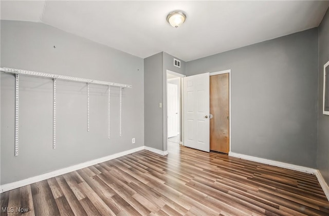 2258 Jacobs Rd, Youngstown, OH 44505 - unfurnished bedroom featuring baseboards, visible vents, and wood finished floors