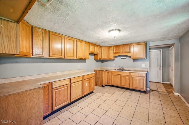 2258 Jacobs Rd, Youngstown, OH 44505 - kitchen featuring a sink, a textured ceiling, light tile patterned flooring, and light countertops