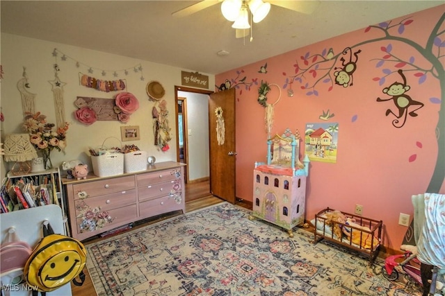 bedroom with ceiling fan and wood finished floors