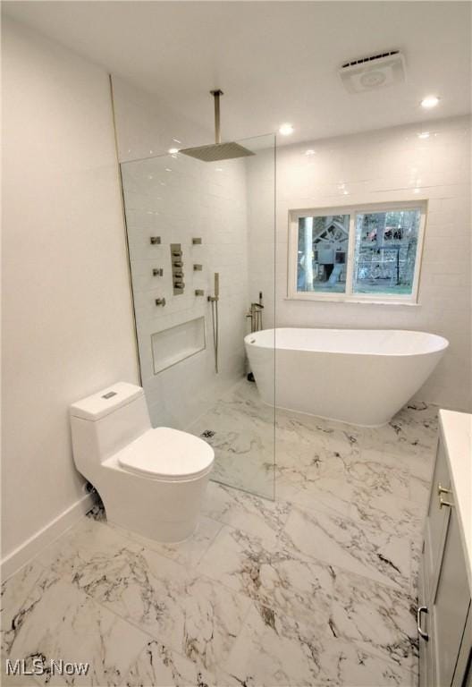 bathroom featuring walk in shower, marble finish floor, toilet, vanity, and a soaking tub