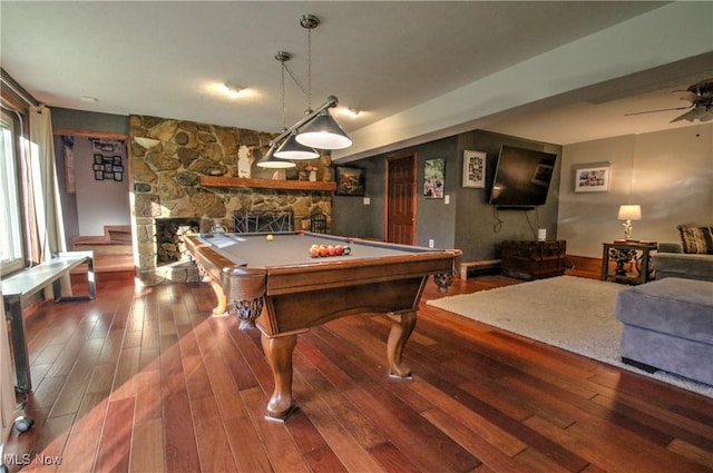 recreation room with wood finished floors, a ceiling fan, billiards, and a fireplace