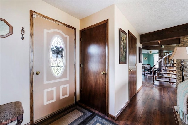 foyer with baseboards, stairs, wood finished floors, and a healthy amount of sunlight