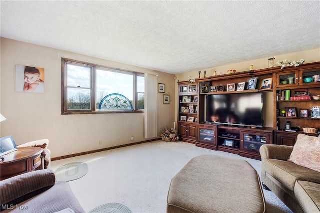carpeted living area with a textured ceiling and baseboards