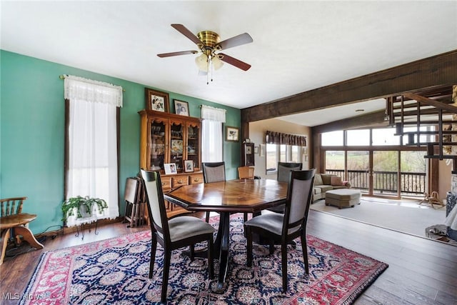 dining room featuring ceiling fan, vaulted ceiling, and wood finished floors