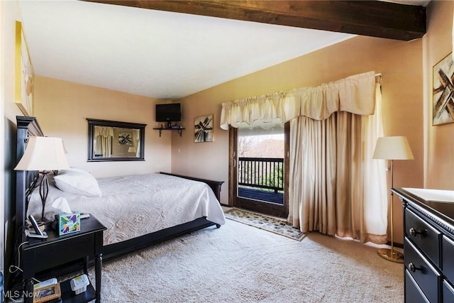 carpeted bedroom featuring access to outside and beamed ceiling