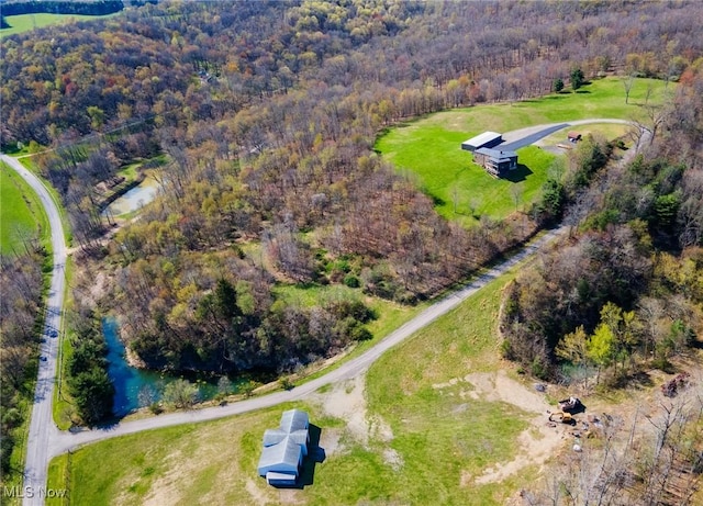 birds eye view of property with a forest view
