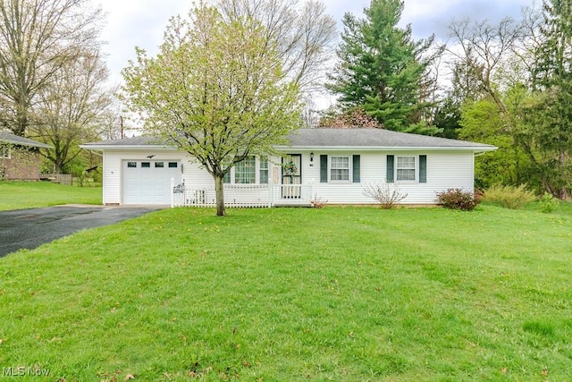 ranch-style house with aphalt driveway, a front lawn, and an attached garage