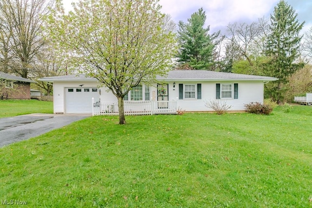 ranch-style home featuring a garage, aphalt driveway, and a front lawn