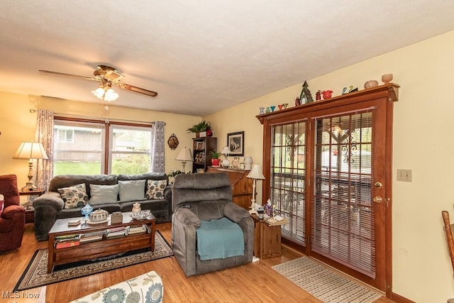 living area featuring wood finished floors and ceiling fan