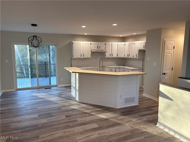 kitchen featuring visible vents, baseboards, and dark wood-type flooring