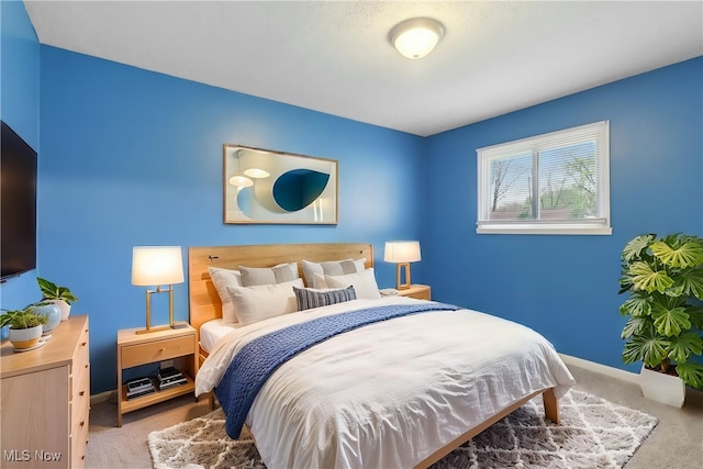 bedroom with carpet and baseboards